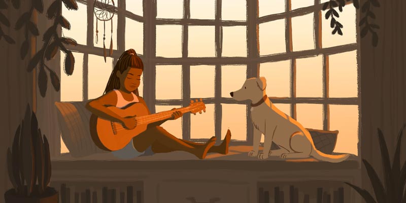 young black girl playing guitar with her dog